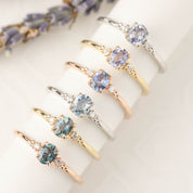 Six estel Ring featuring a 0.40ct unheated oval sapphire and 14k gold natural diamond accents.