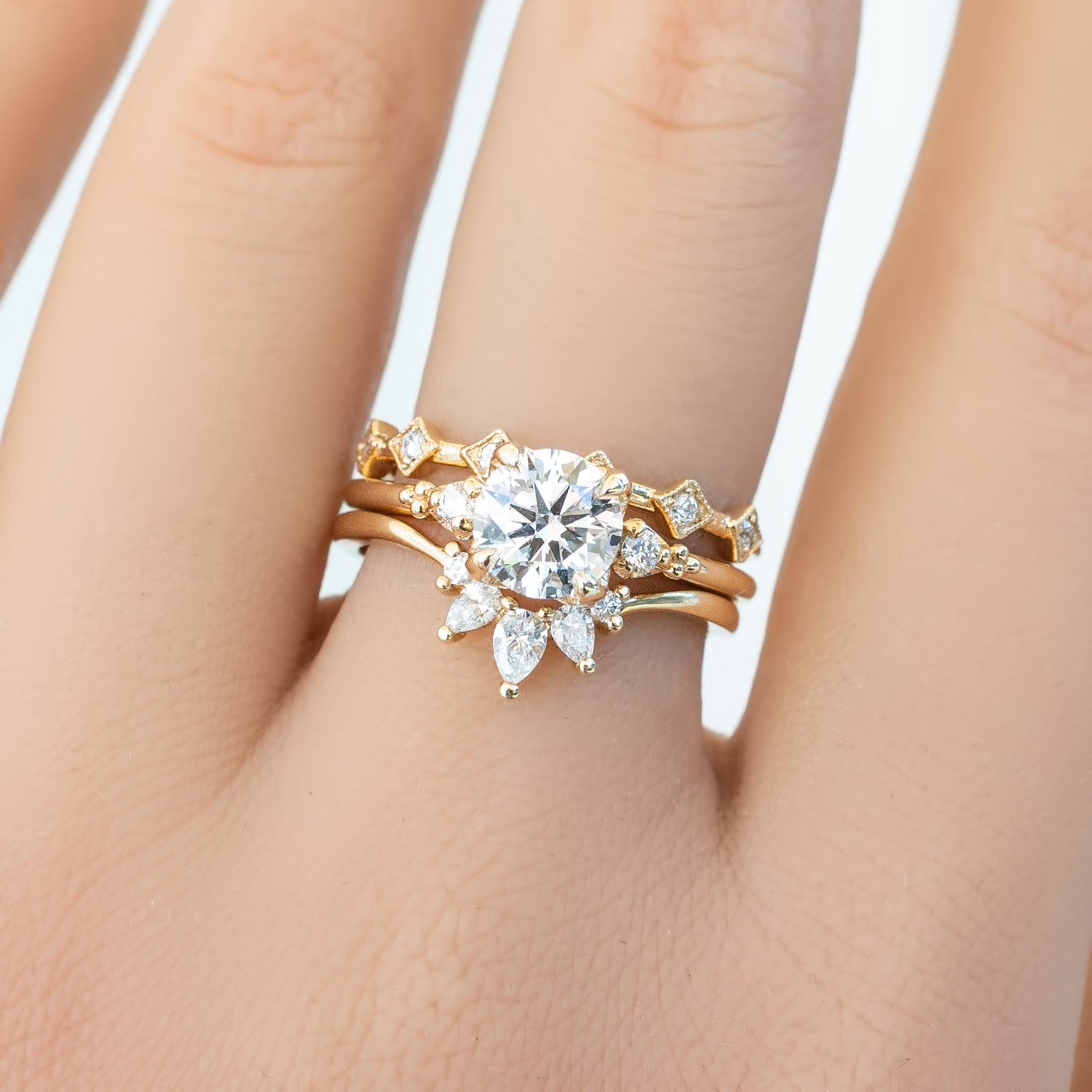 Gloria Ring featuring natural white diamonds set in ethically sourced solid gold band on hand close-up