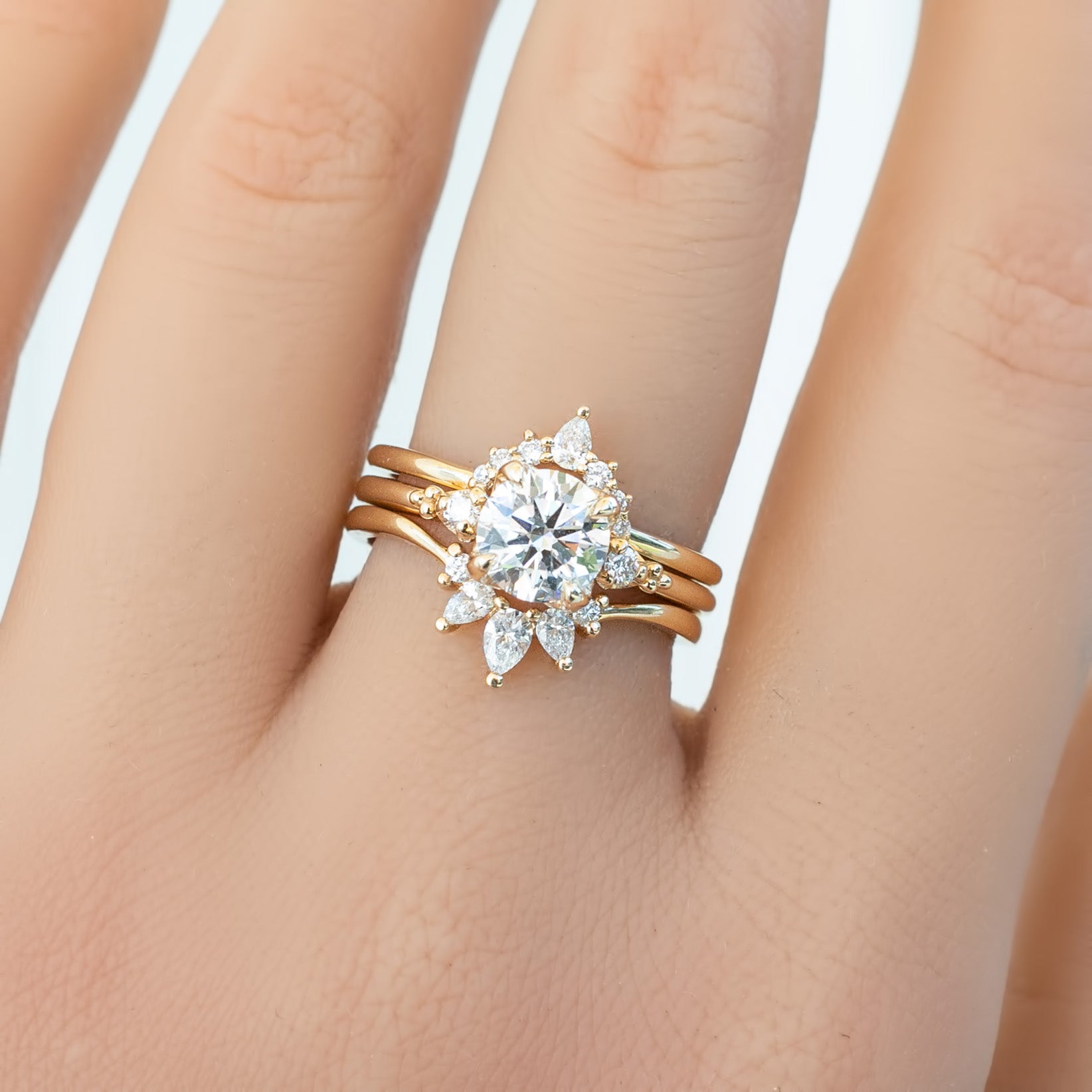 Gloria Ring featuring natural white diamonds in a delicate, ethically sourced gold setting on a hand.