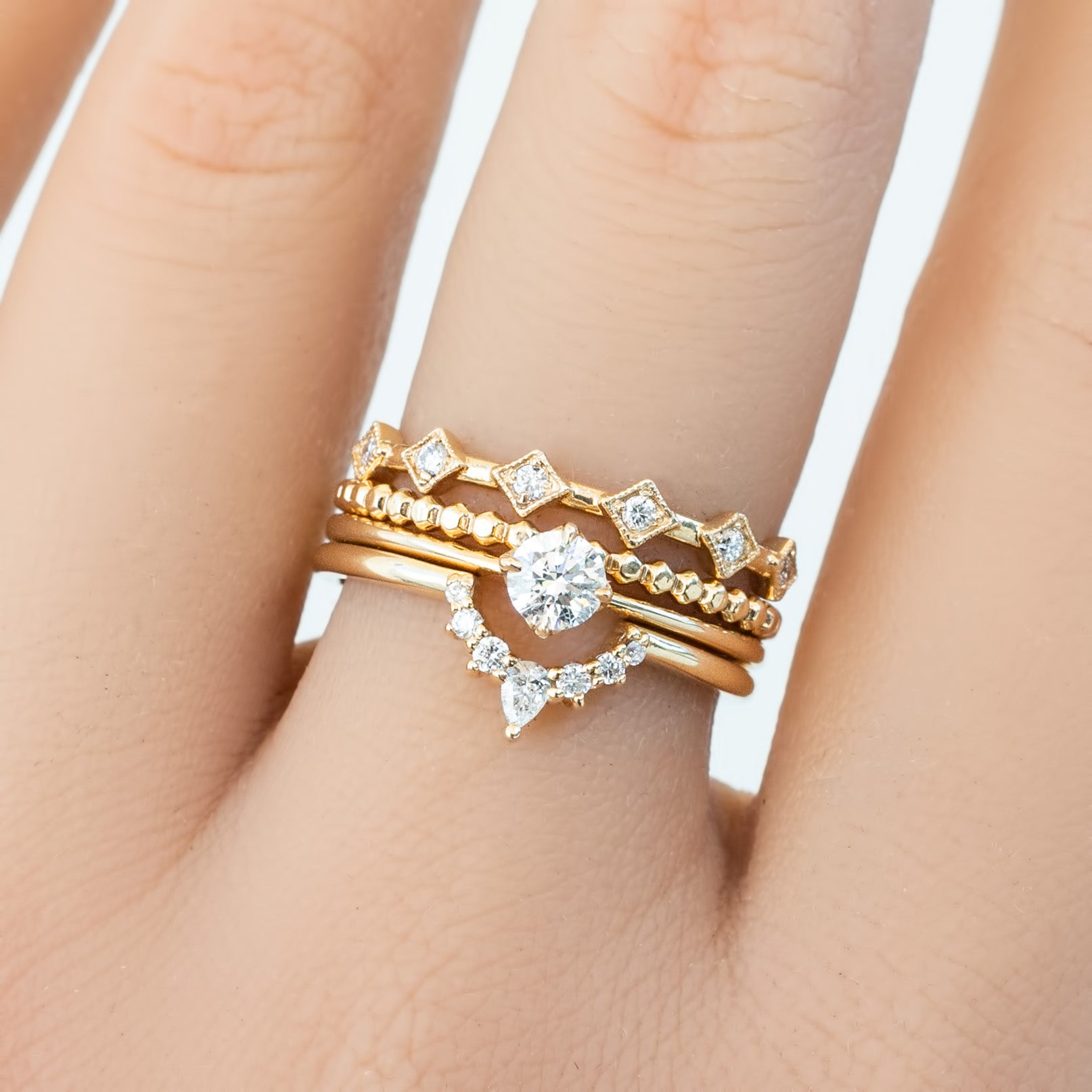 Bella's Crown Ring stacked with delicate gold bands featuring natural white diamonds, handmade and ethically sourced jewelry.