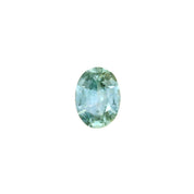 An oval-cut teal blue Montana Sapphire with visible inclusions under magnification.
