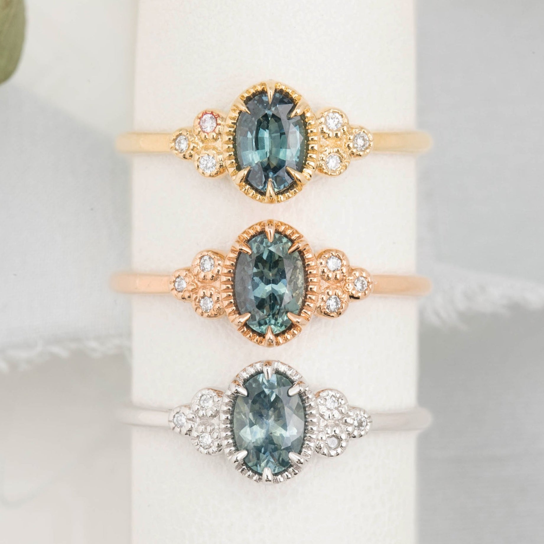 3 Celine Ring featuring a 0.60ct blue Montana sapphire in a 14k yellow, rose and white gold with six natural diamond accents