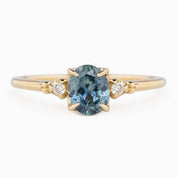 Estel Ring featuring an oval 0.85ct oval teal Montana sapphire with natural diamond accents in 14k yellow gold