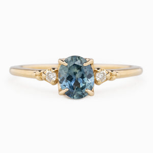 Estel Ring featuring an oval 0.85ct oval teal Montana sapphire with natural diamond accents in 14k yellow gold