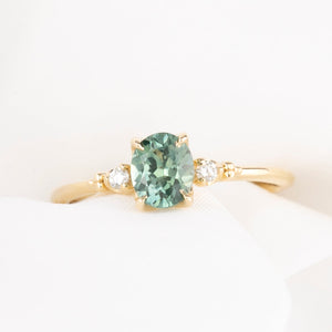 Estel Ring featuring an oval green Montana sapphire with natural diamond accents in 14k gold.