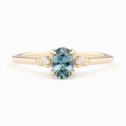 Estel Ring featuring a 0.60ct blue-green oval Montana sapphire and natural diamond accents in 14k yellow gold