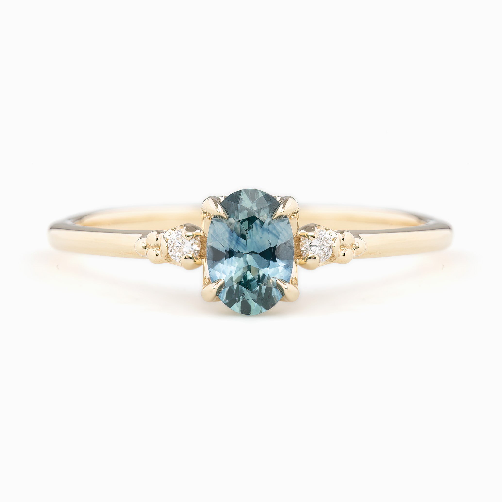 Estel Ring featuring a 0.60ct blue-green oval Montana sapphire and natural diamond accents in 14k yellow gold