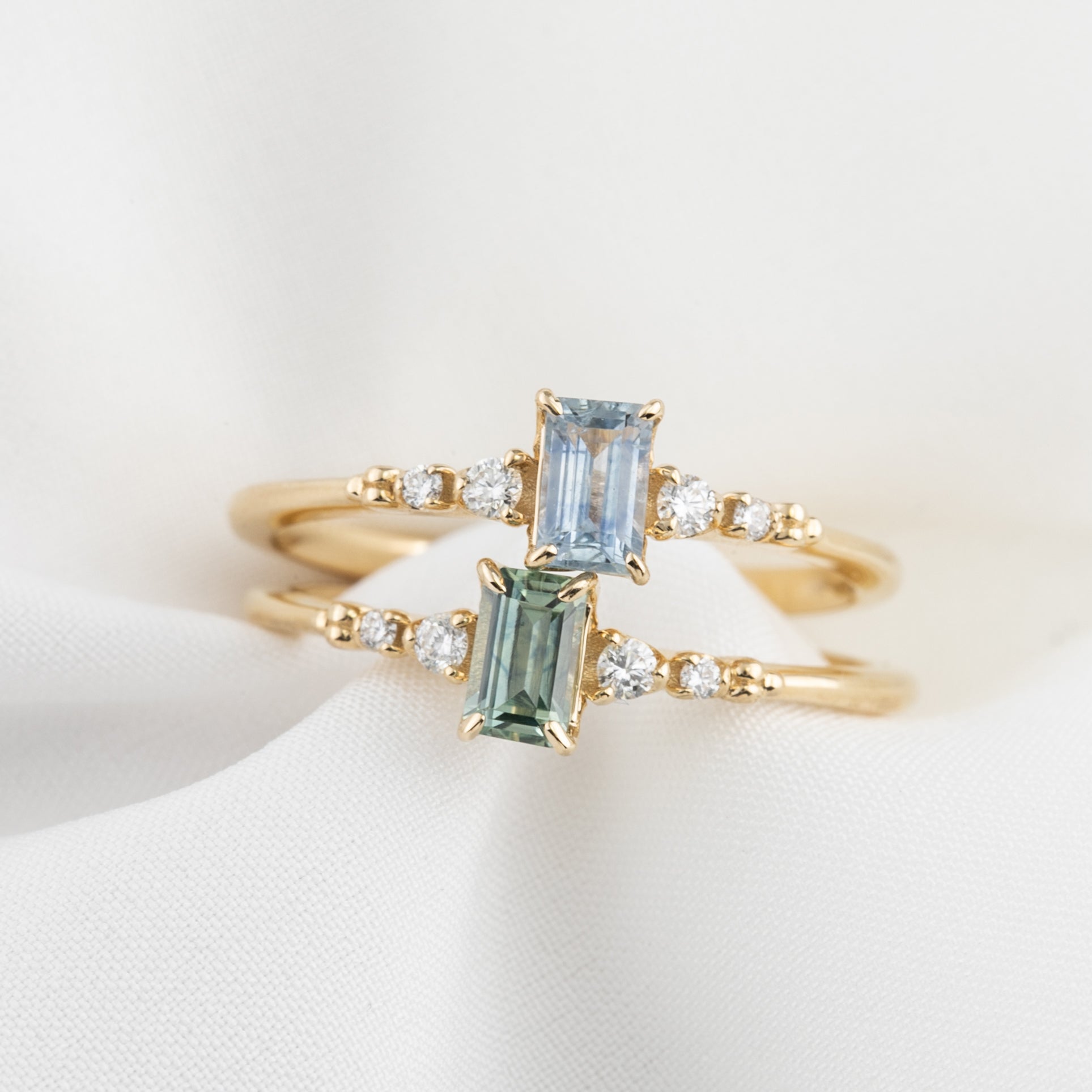 Two Estel Fleur Ring featuring a 0.45ct emerald cut Montana sapphire in 14k yellow gold