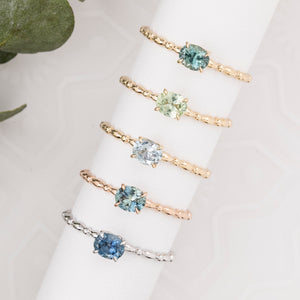 Five Candy rings featuring an oval 0.45ct Montana sapphire in a 14k gold minimalist setting.