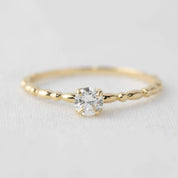 Delicate 14k yellow gold candy ring with 0.25ct round brilliant cut diamond in four prong setting on beaded band