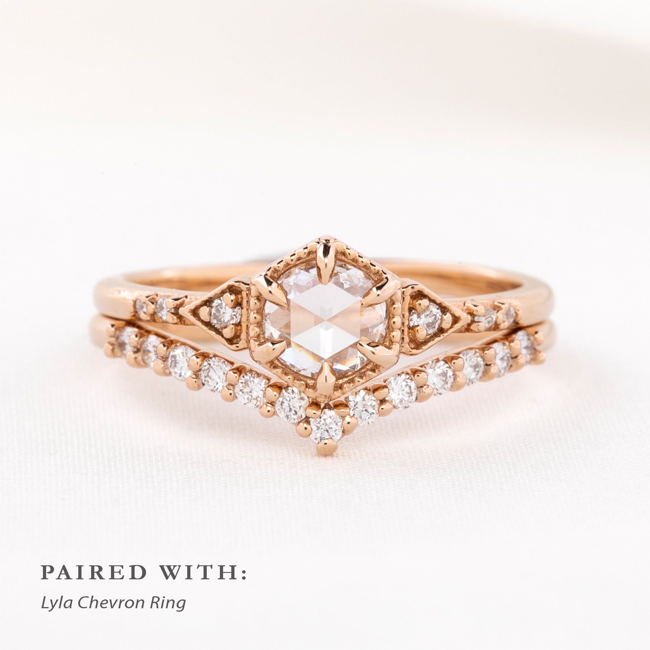 An art Deco-inspired 14k rose gold featuring a 0.45ct round rose cut diamond stacked with a band
