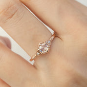 An art Deco-inspired 14k rose gold featuring a 0.45ct round rose cut diamond worn on a finger