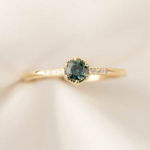 Hexagon ring with a teal blue sapphire and natural diamond accents in 14k yellow gold 