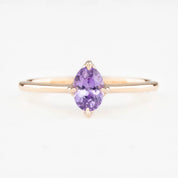 Ring with a purple gemstone on a white background