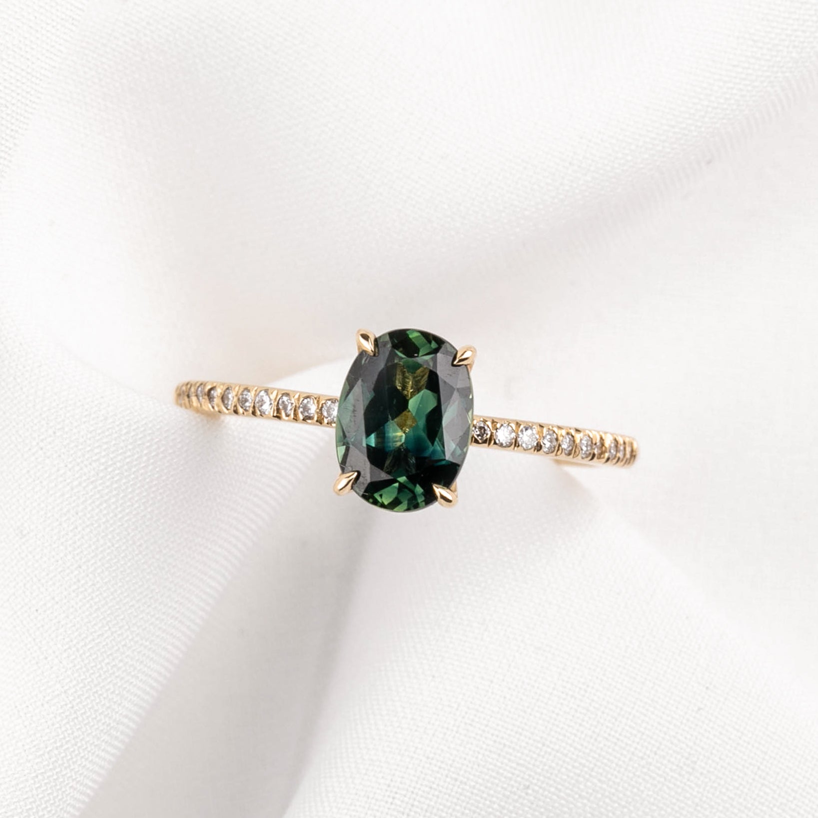 14k yellow gold ring with 1.53ct unheated oval green Queensland sapphire and small natural accent diamonds