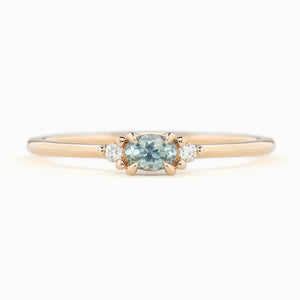 Emilie Ring featuring a 0.20ct East-West set oval Montana sapphire in 14k rose gold.