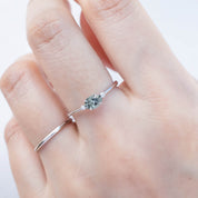 The Emilie 0.45ct Umba green sapphire ring worn to show the unique horizontal orientation and white gold band on hand.