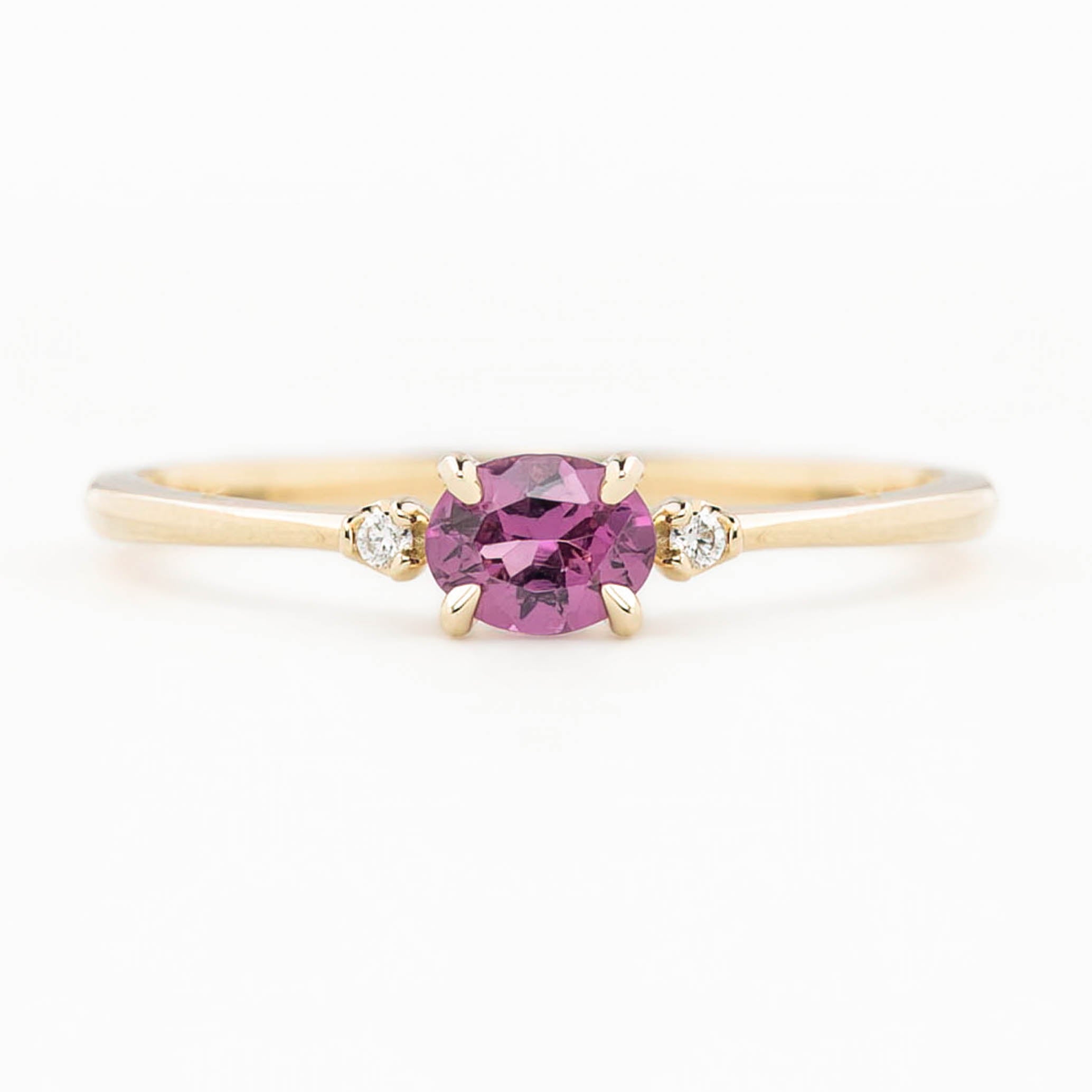 Emilie Ring featuring a pink 0.45ct East-West unheated Umba sapphire in 14k yellow gold.