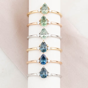 Six 14k gold ring featuring a Montana pear-cut sapphire with natural accent diamonds.