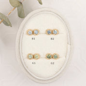 Set of gold earrings with gemstones on a white background