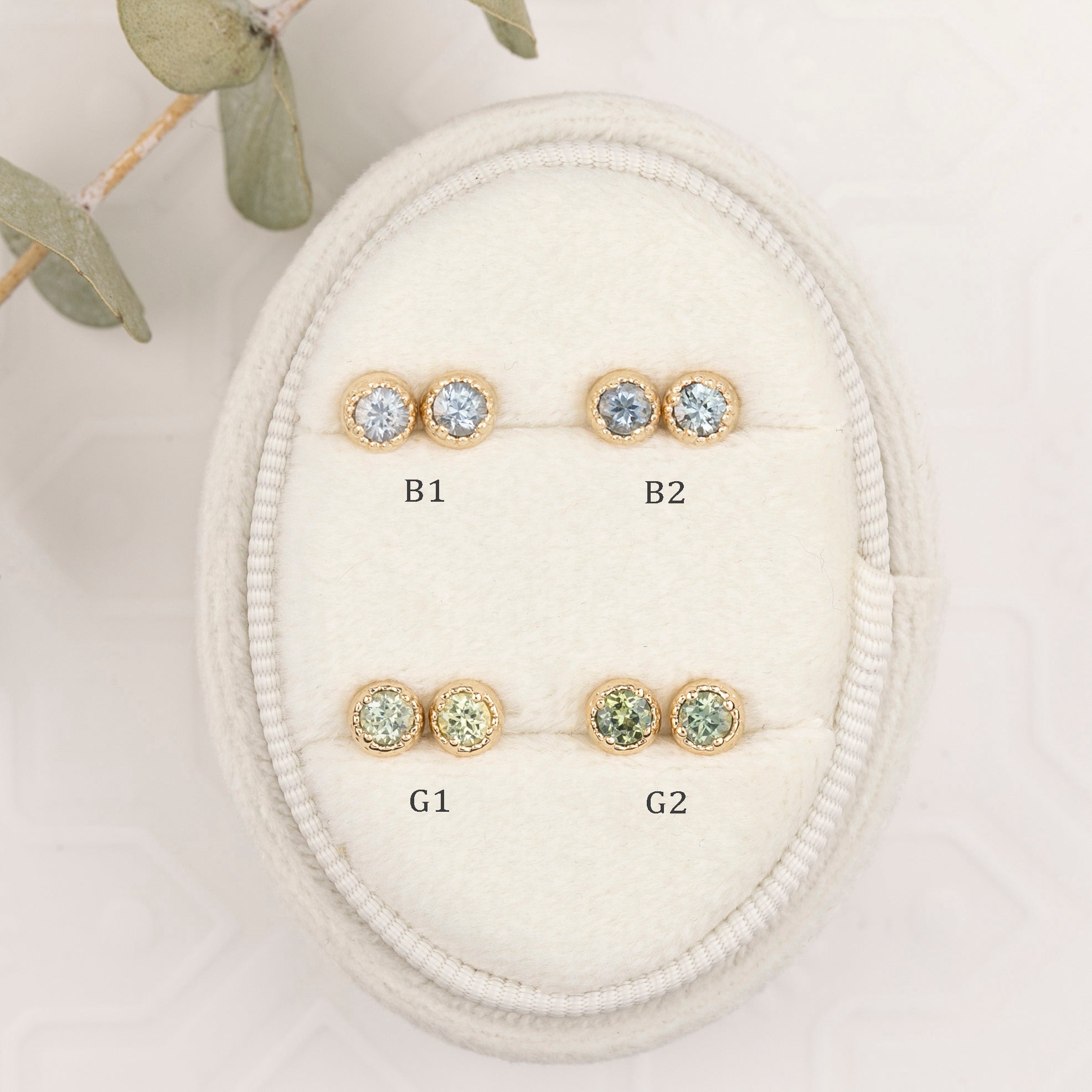 Set of gold earrings with gemstones on a white background