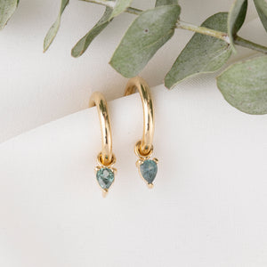 14K yellow gold hoop earrings with pear-cut blue-green Montana sapphire charms
