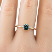 Audrey Ring, 0.73ct Queensland Sapphire with a green gemstone on a white background