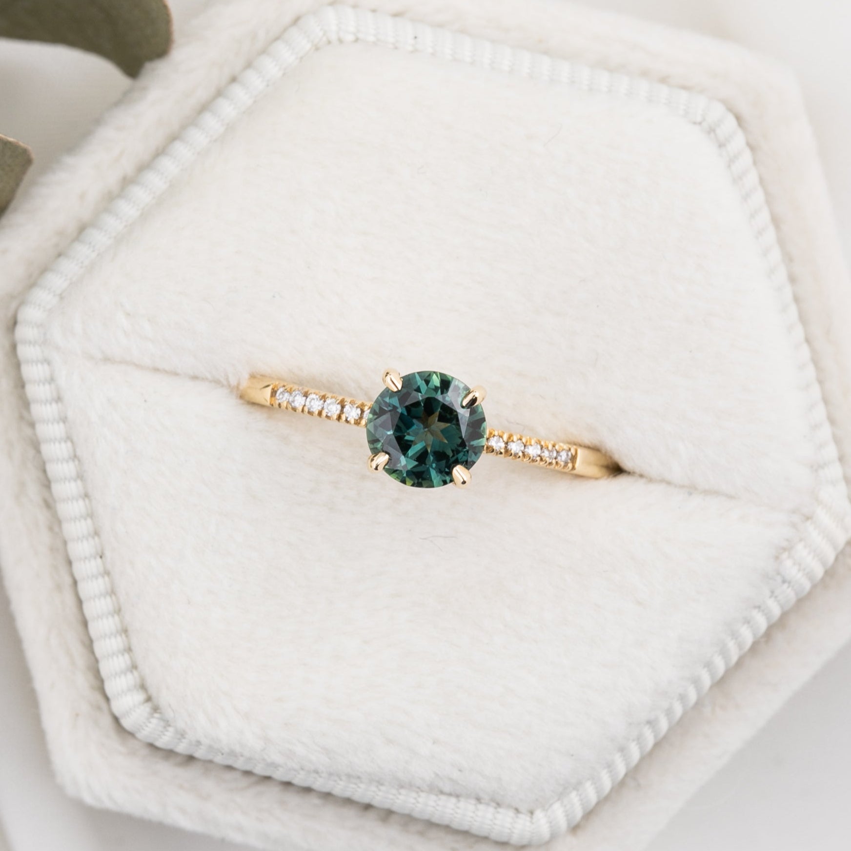 Audrey Ring, 0.73ct Queensland Sapphire with a green gemstone on a white background