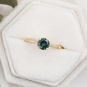 Audrey Ring, 0.73ct Queensland Sapphire with a green gemstone on a white background