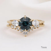Lily's Tiara Ring featuring a 7mm deep blue center gemstone with ethically sourced gold and white diamonds