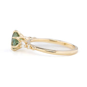 Side view of Estel Fleur Petal Ring with a 1.53ct round green Montana sapphire and diamond accents in 14k yellow gold.