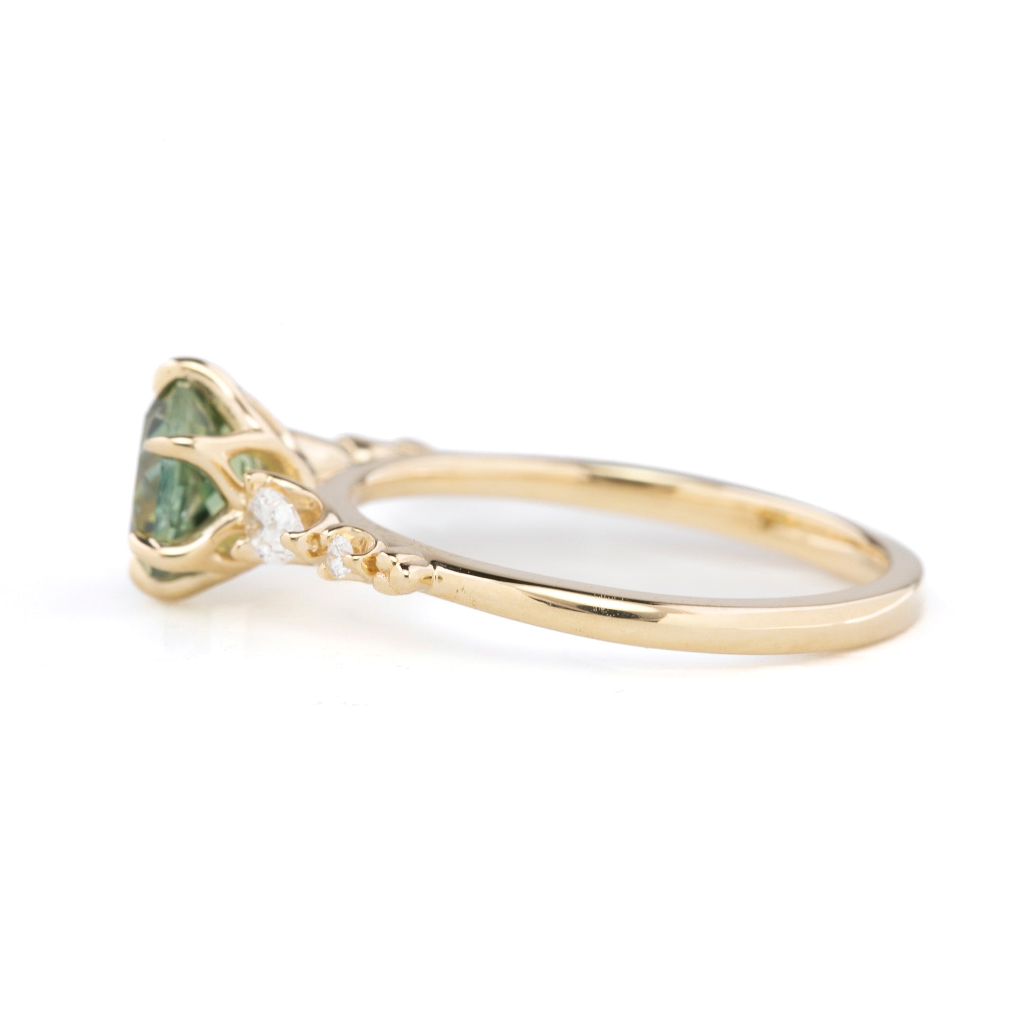 Side view of Estel Fleur Petal Ring with a 1.53ct round green Montana sapphire and diamond accents in 14k yellow gold.