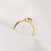 Gold ring with a diamond on a white background