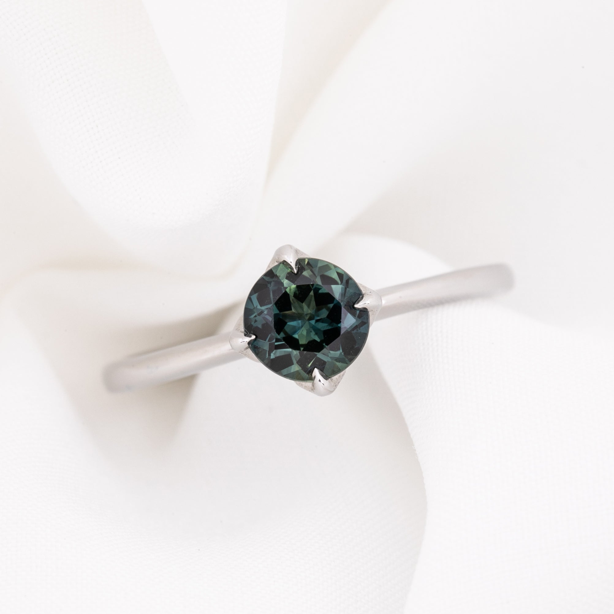 Alice Ring, 0.85ct Queensland Sapphire ring with a green gemstone on a white background