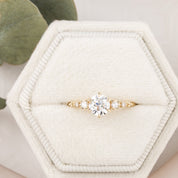 A GIA certified 0.70ct round brilliant diamond six prongs ring setting in 14k yellow gold, displayed in an ivory velvet ring box.
