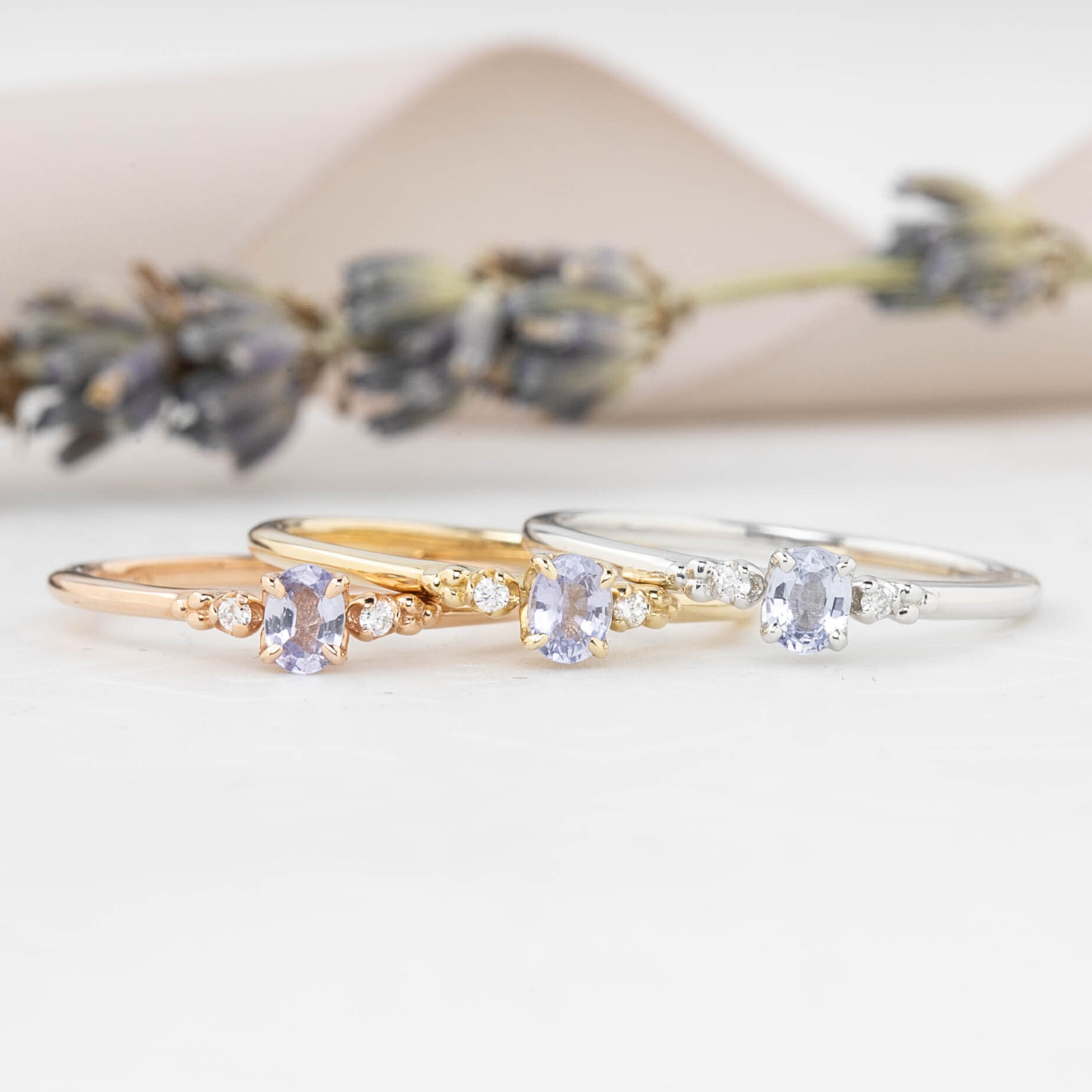 Three Estel Ring featuring a 0.20ct light blue unheated oval sapphire and 14k gold diamond accents