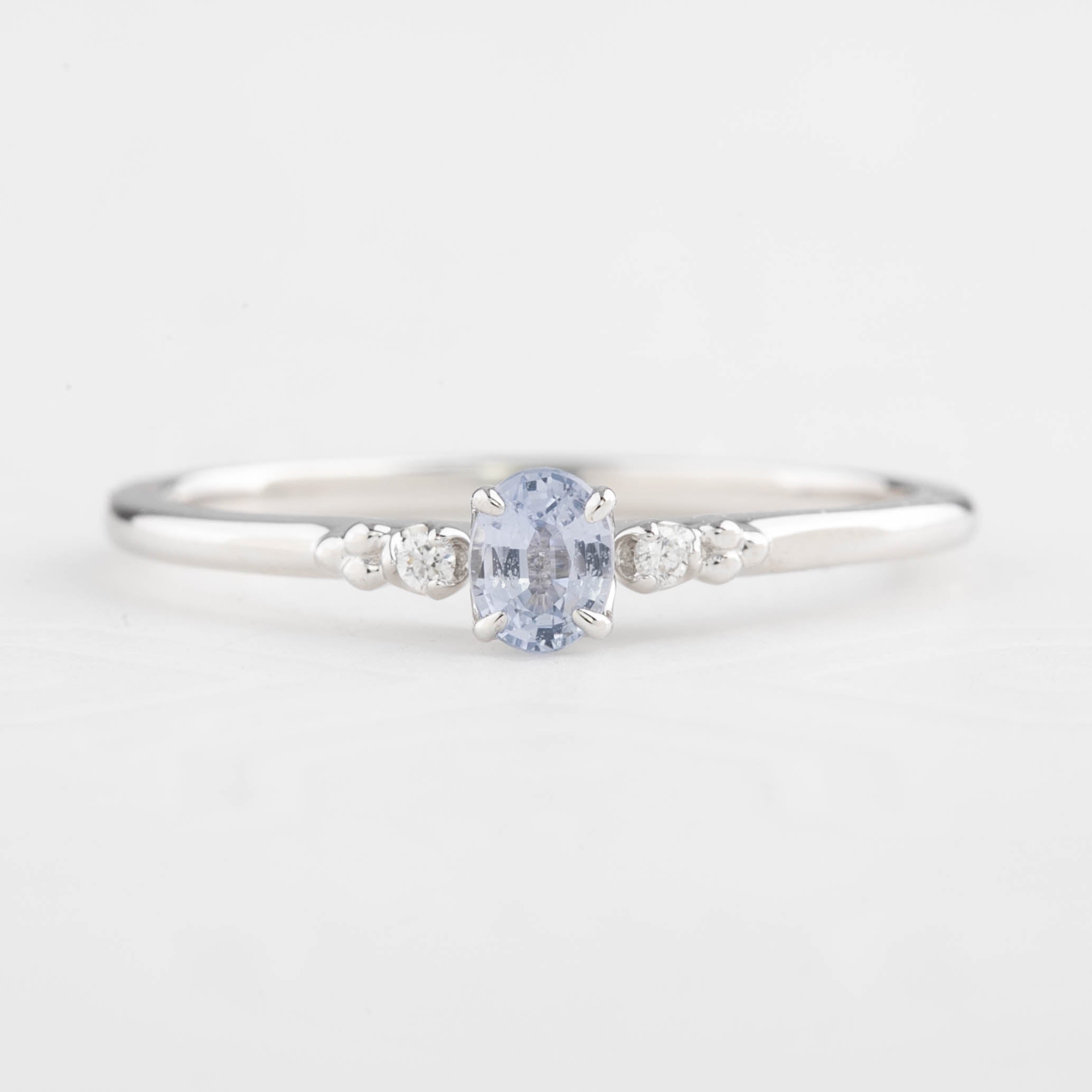 Estel Ring featuring a 0.20ct light blue unheated oval sapphire and 14k white gold diamond accents