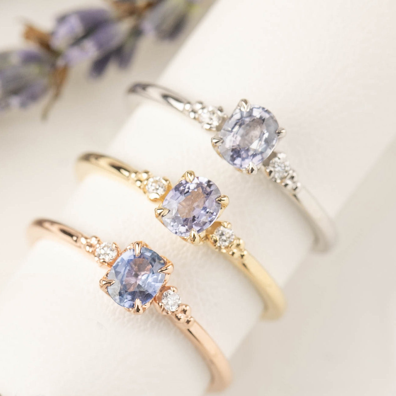 Three Estel Ring featuring a 0.40ct light blue unheated oval sapphire and 14k gold diamond accents
