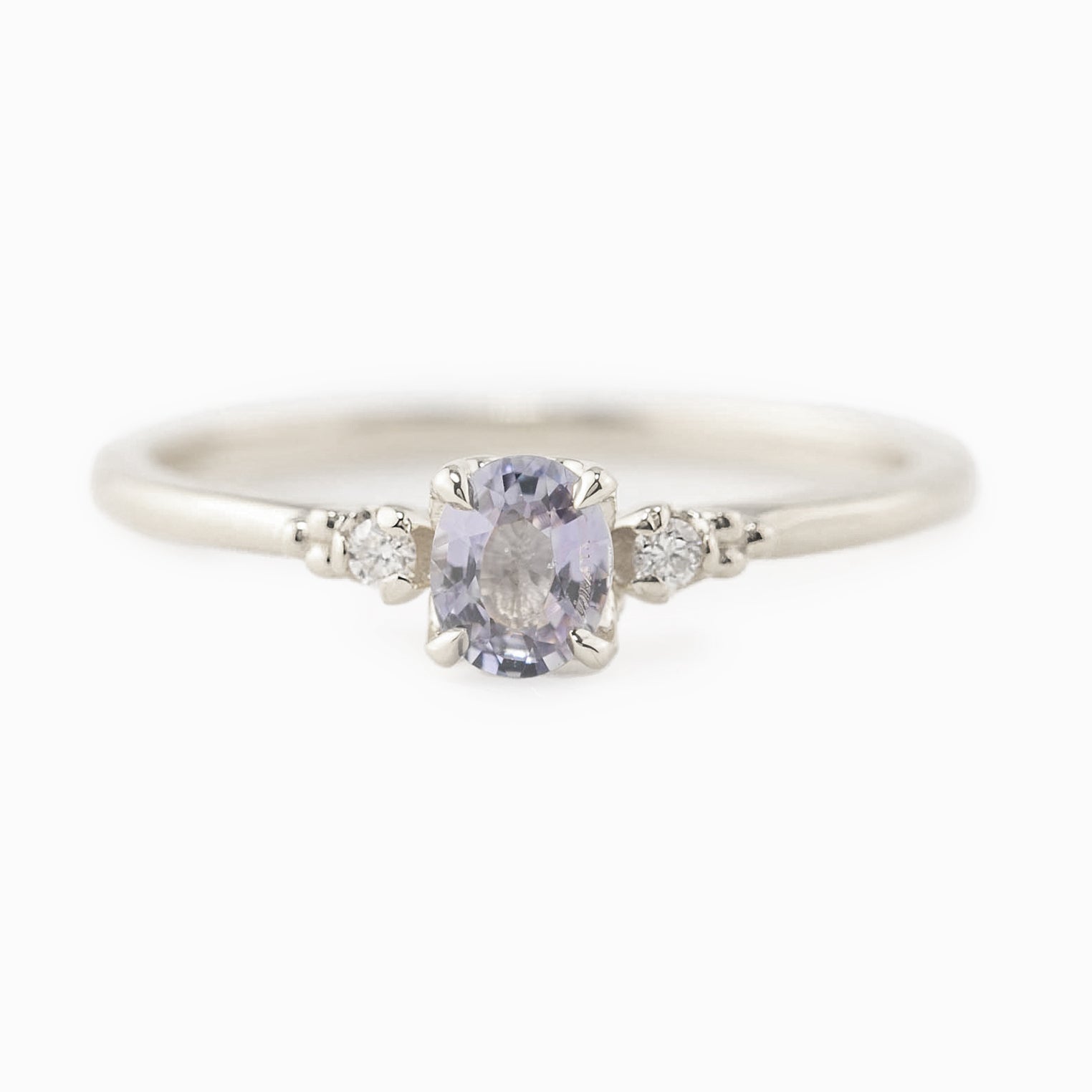 Estel Ring featuring a 0.40ct light blue unheated oval sapphire and 14k white gold diamond accents