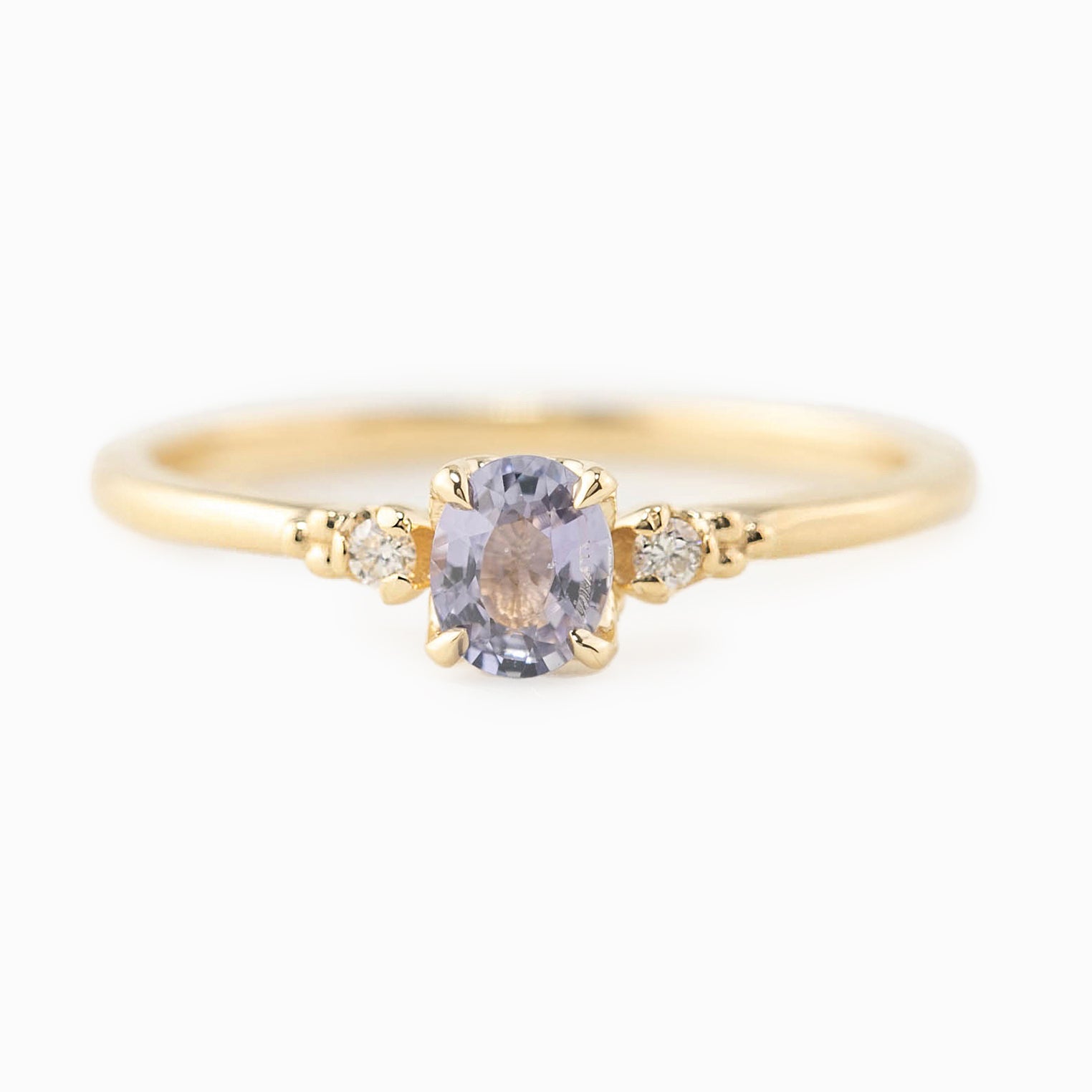 Estel Ring featuring a 0.40ct light blue unheated oval sapphire and 14k yellow gold diamond accents