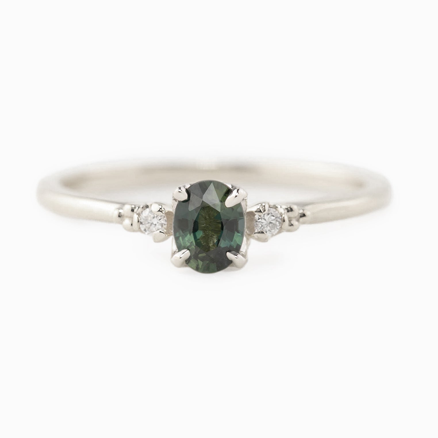 Estel Ring featuring a 0.40ct green unheated oval sapphire and 14k white gold diamond accents