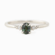 Estel Ring featuring a 0.40ct green unheated oval sapphire and 14k white gold diamond accents