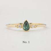 Estel Bezel Ring with a 0.35ct unheated teardrop sapphire and two natural diamond accents in 14k gold.