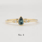 Estel Bezel Ring with a 0.35ct unheated teardrop sapphire and two natural diamond accents in 14k gold.