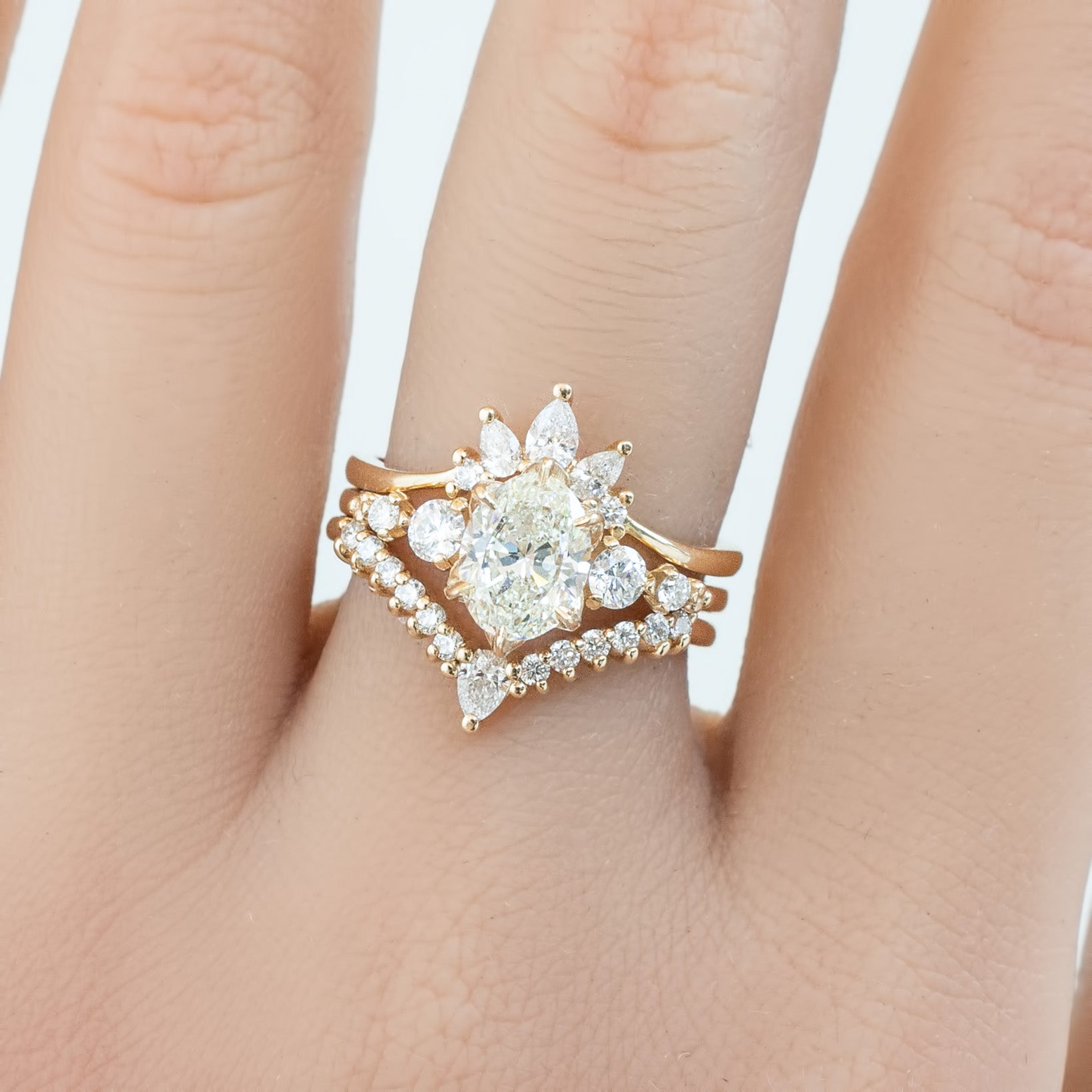 Gloria Ring featuring natural white diamonds set in ethically sourced gold, shown stacked with a matching diamond band.