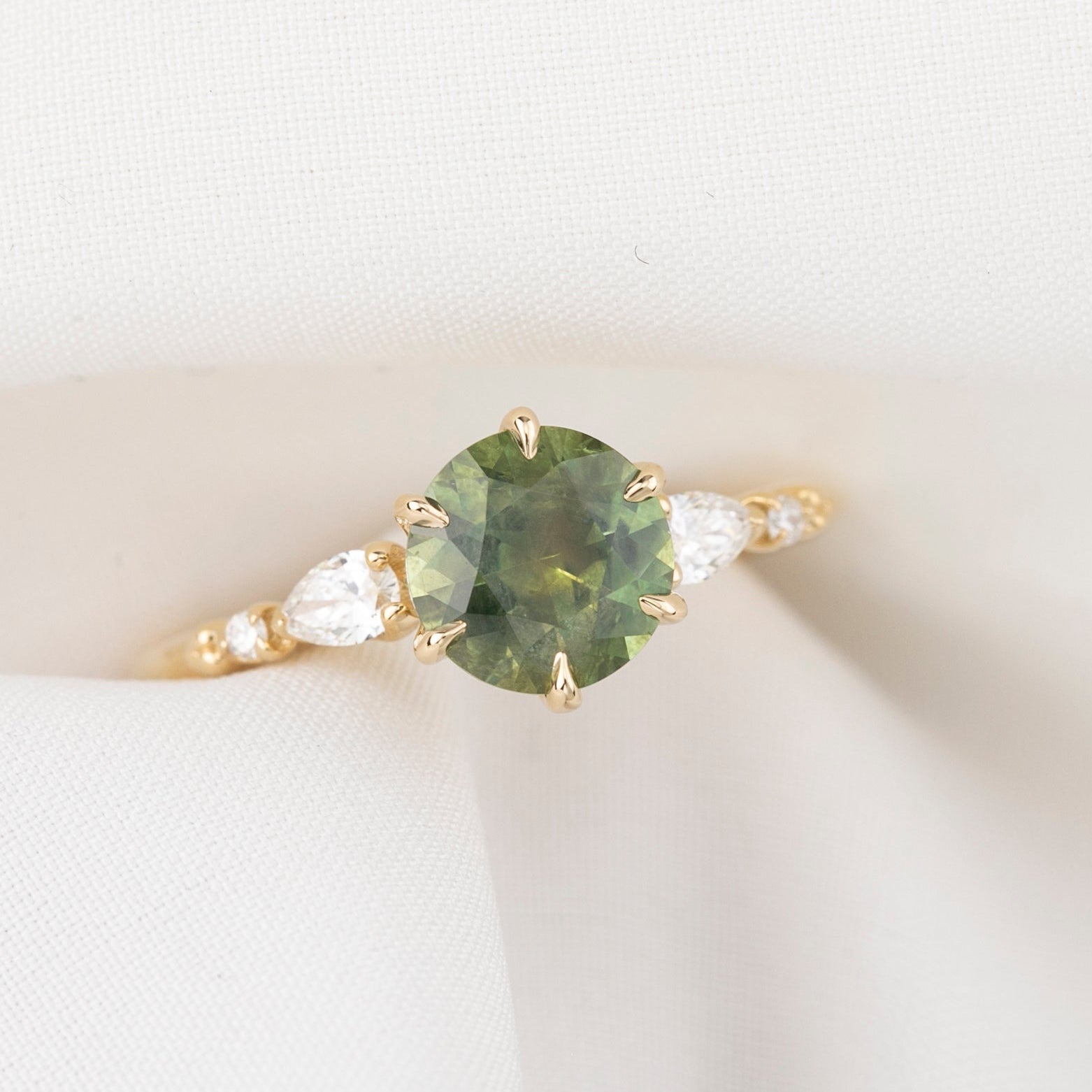 Estel Fleur Petal Ring with a 1.53ct round green Montana sapphire and diamond accents in 14k yellow gold.