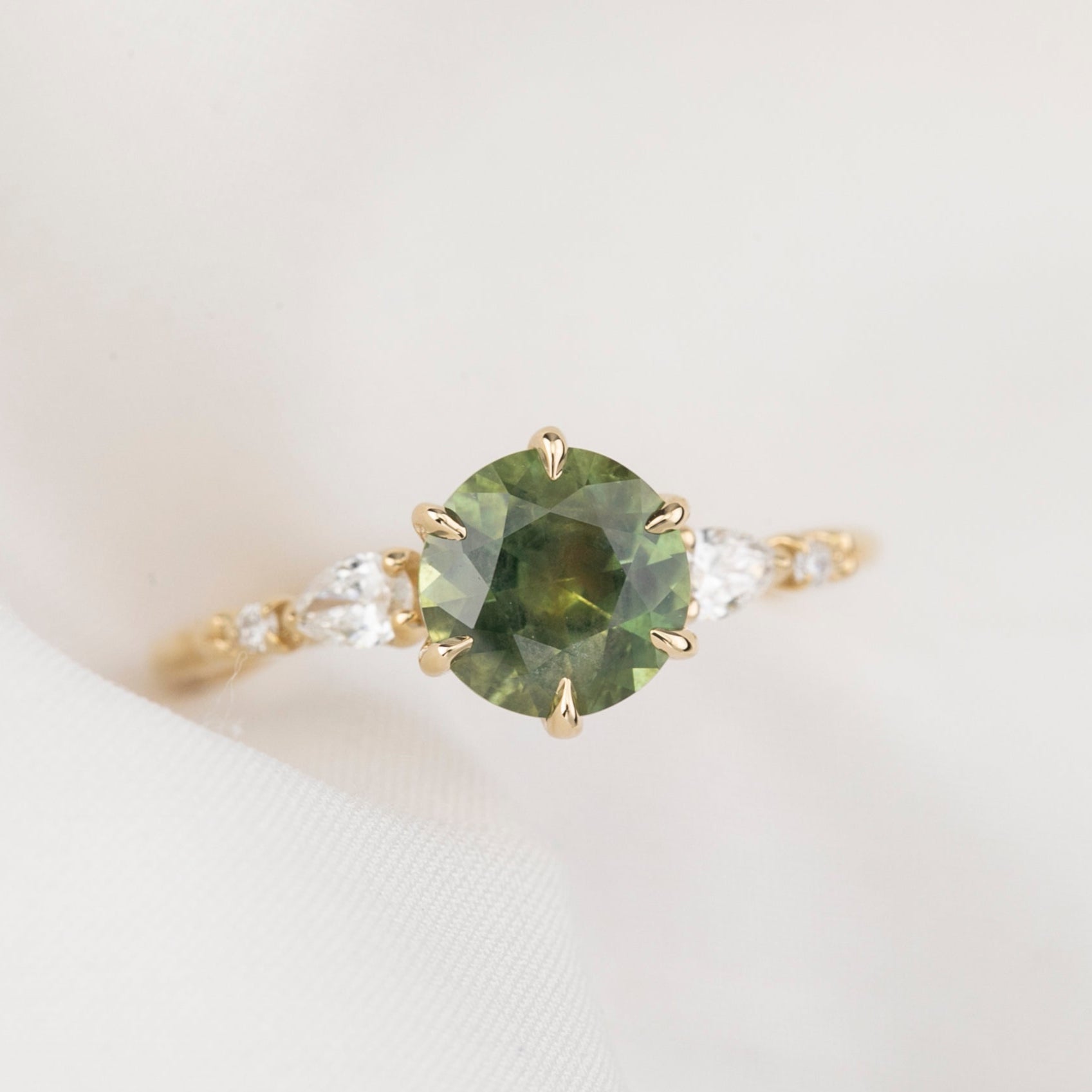 Estel Fleur Petal Ring with a 1.53ct round green Montana sapphire and diamond accents in 14k yellow gold.