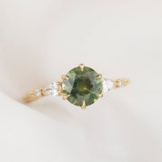 Estel Fleur Petal Ring with a 1.53ct round green Montana sapphire and diamond accents in 14k yellow gold.
