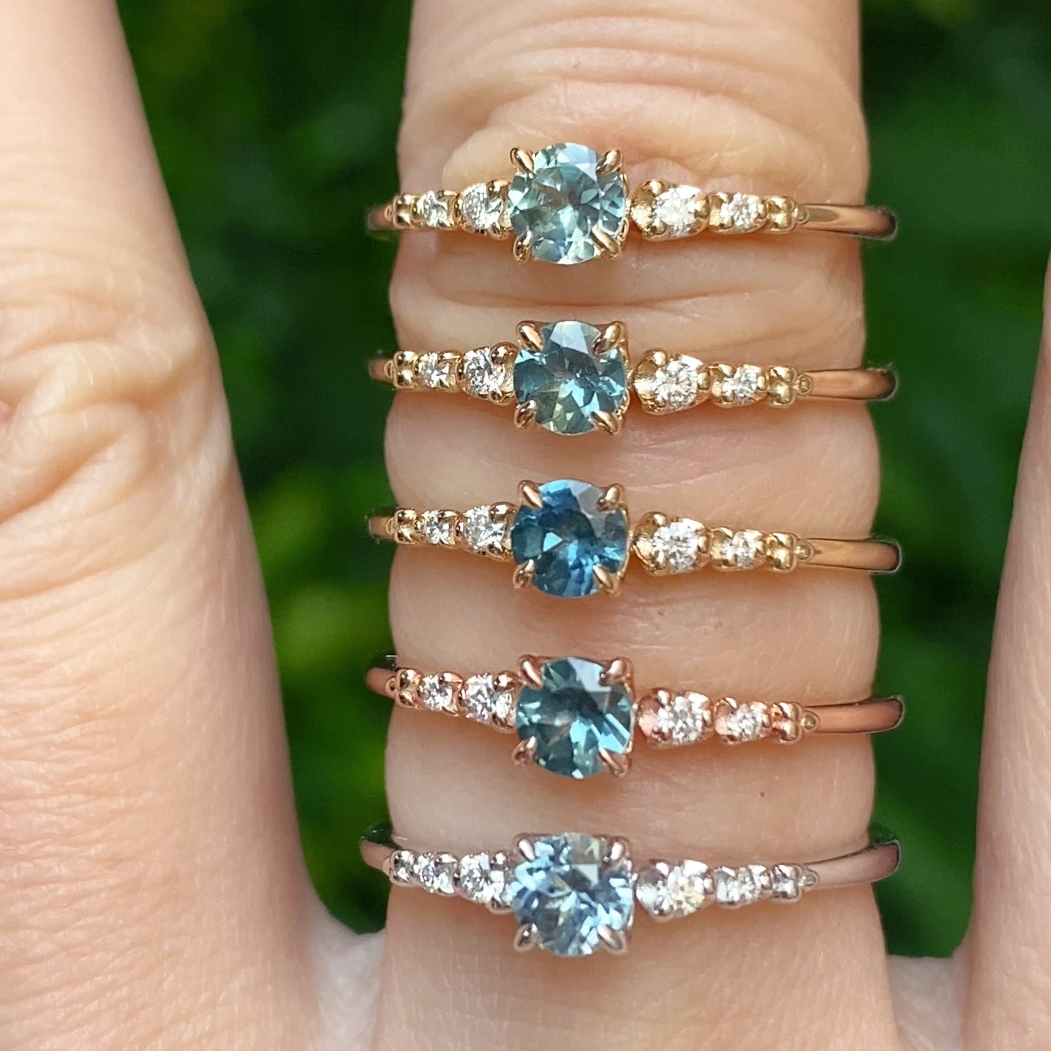 Six unique Estel Fleur rings featuring 0.40ct Montana sapphires in yellow, rose, and white gold.