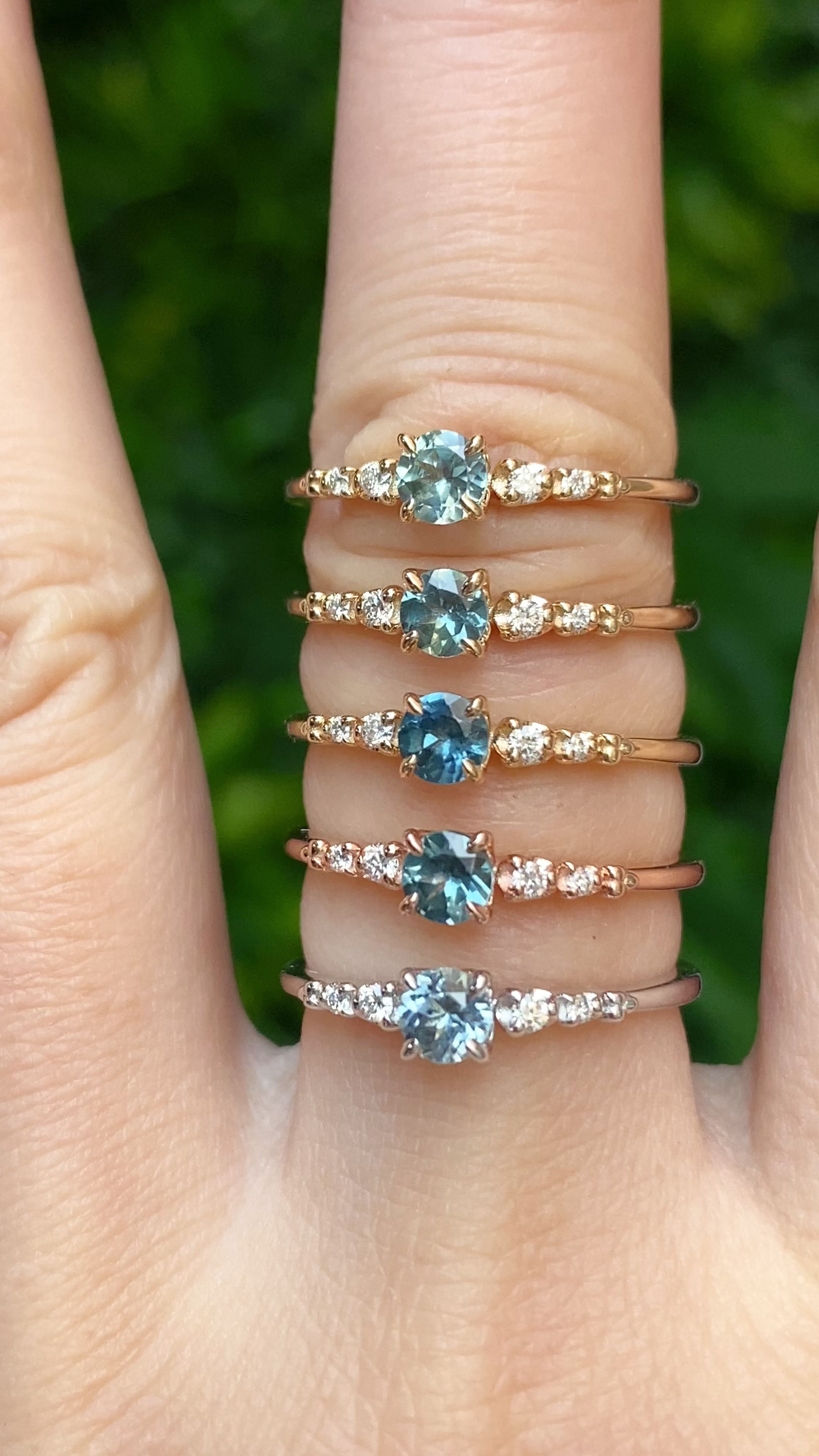 Six unique Estel Fleur rings featuring 0.40ct Montana sapphires in yellow, rose, and white gold.